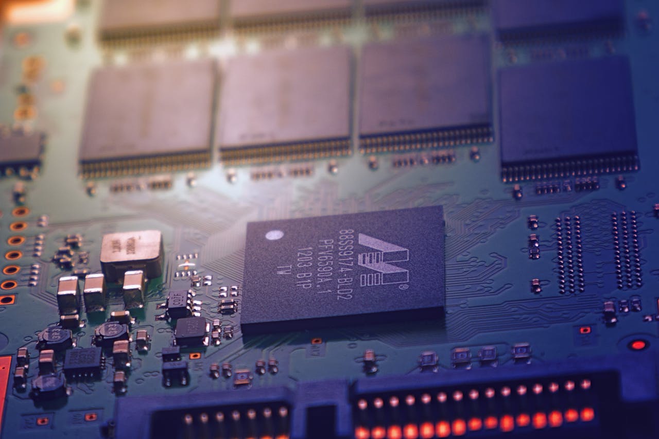 Services-01 Detailed image of an electronic circuit board showing microchips and intricate wiring in a modern technological setting.