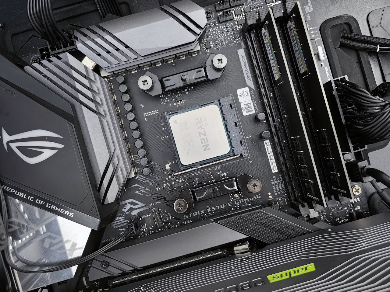creative Detailed view of a gaming motherboard, showcasing an AMD processor and components.
