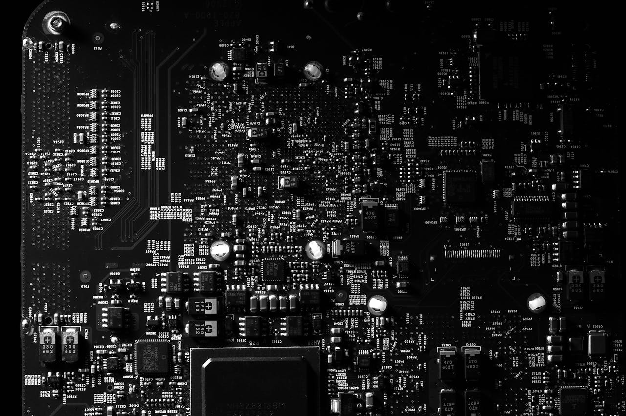 Services-02 Detailed black and white photo of a circuit board showing intricate components, perfect for tech projects.